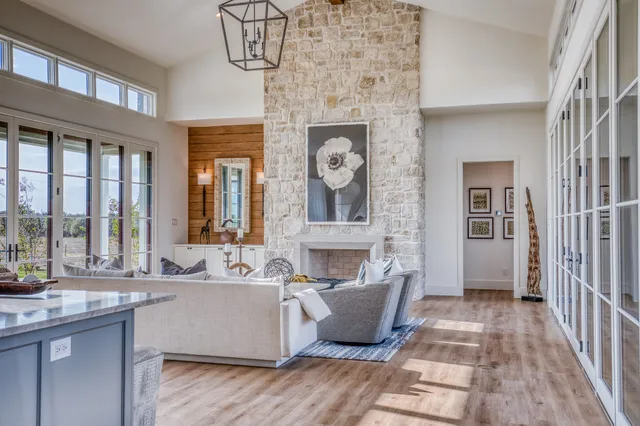 a living room with fireplace furniture and a large window