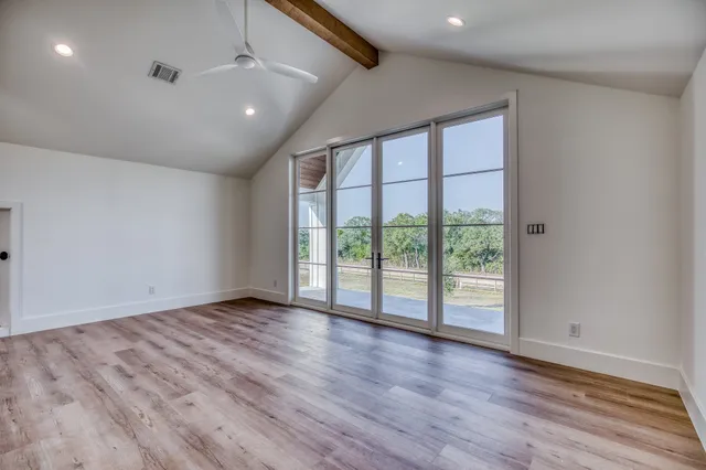 a large kitchen with a sink and cabinets