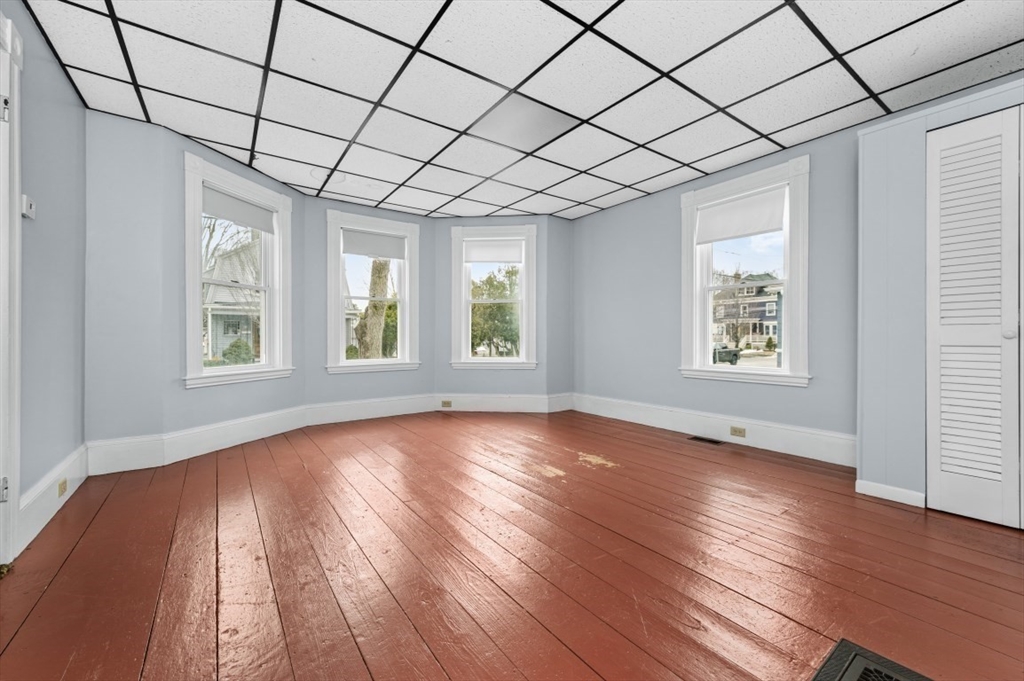 6 Trask Street Danvers, MA 01923 - Photo 32 of 42 an empty room with wooden floor and windows