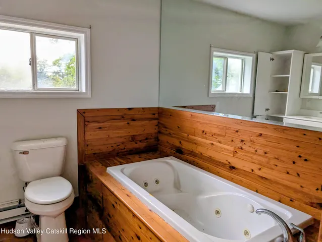 a bathroom with a sink toilet and window