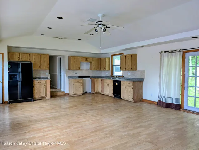 a view of a kitchen with a sink and cabinets