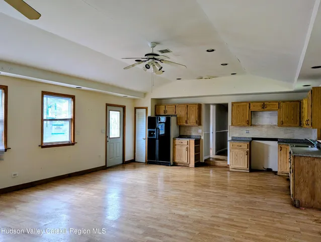 a view of a livingroom with furniture window and wooden floor