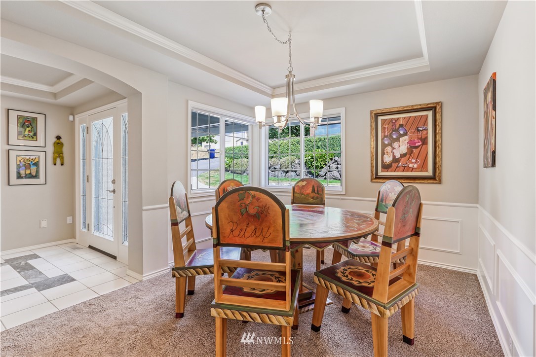 1325 North 24th Street Renton, WA 98056 - Photo 13 of 40 a dining room with furniture a chandelier and window