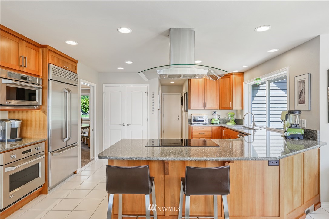 1325 North 24th Street Renton, WA 98056 - Photo 15 of 40 a kitchen with stainless steel appliances granite countertop a stove a refrigerator a oven a sink with island and chairs