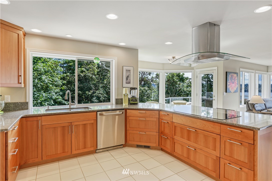 1325 North 24th Street Renton, WA 98056 - Photo 17 of 40 a large kitchen with kitchen island granite countertop a large window cabinets and stainless steel appliances