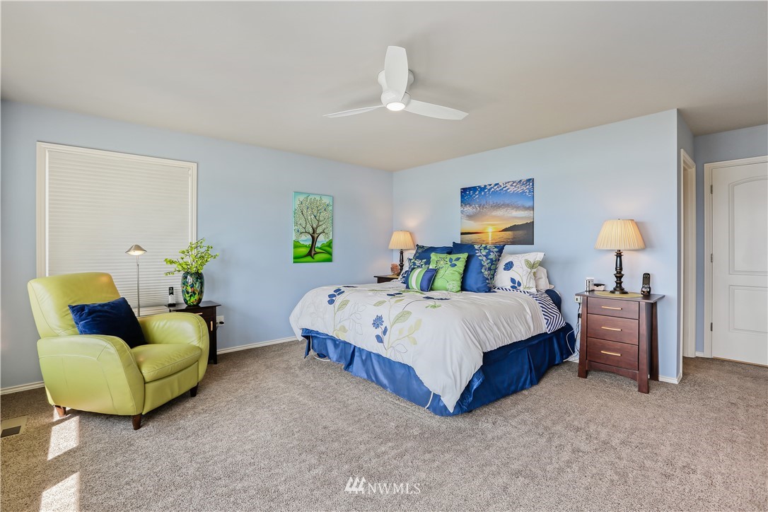1325 North 24th Street Renton, WA 98056 - Photo 26 of 40 a spacious bedroom with a bed and a couch