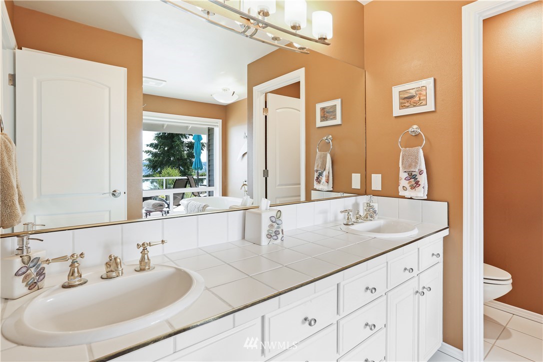 1325 North 24th Street Renton, WA 98056 - Photo 29 of 40 a bathroom with a granite countertop sink and a large mirror