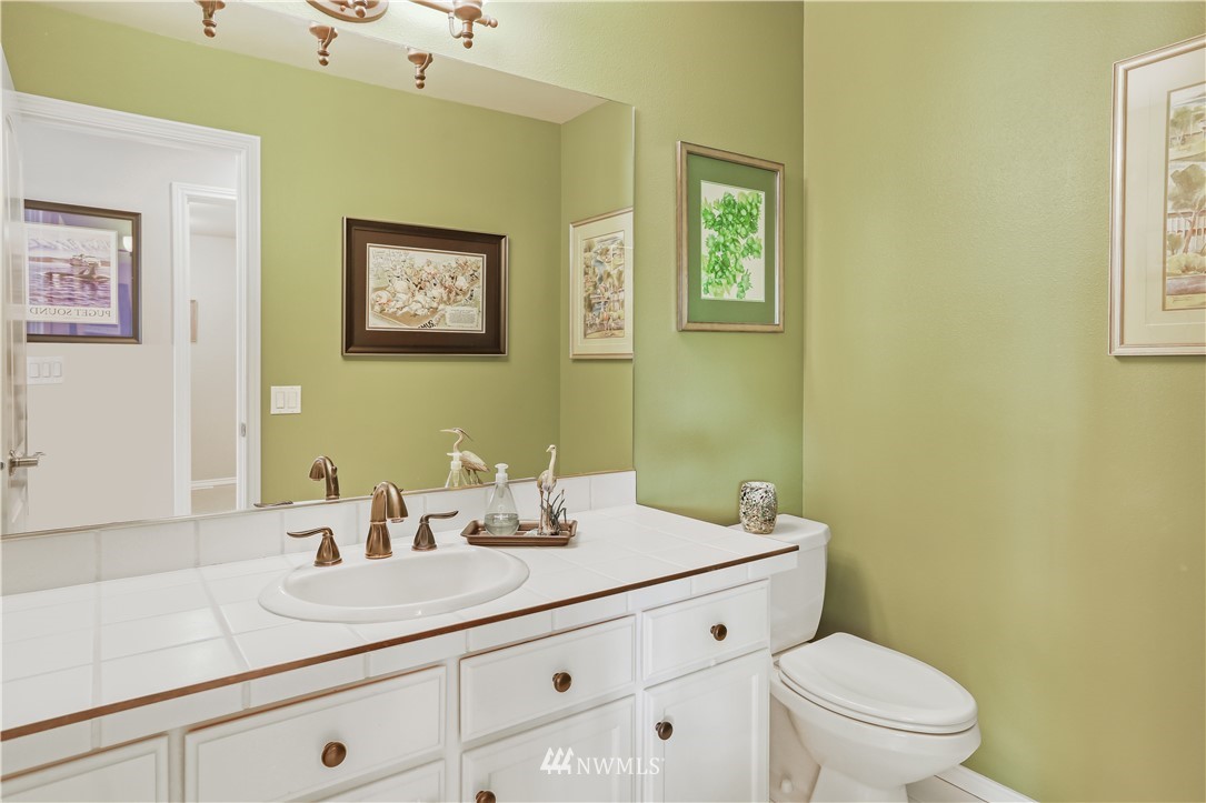 1325 North 24th Street Renton, WA 98056 - Photo 37 of 40 a bathroom with a granite countertop sink mirror and toilet