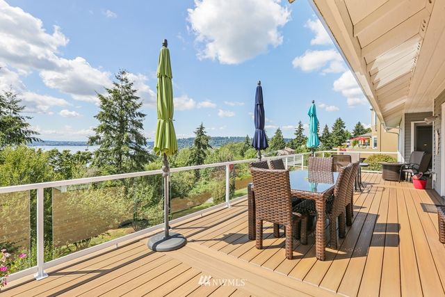 a view of a balcony with wooden floor and outdoor seating