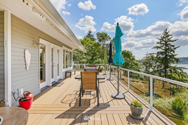 a view of a patio with table and chairs potted plants with wooden floor