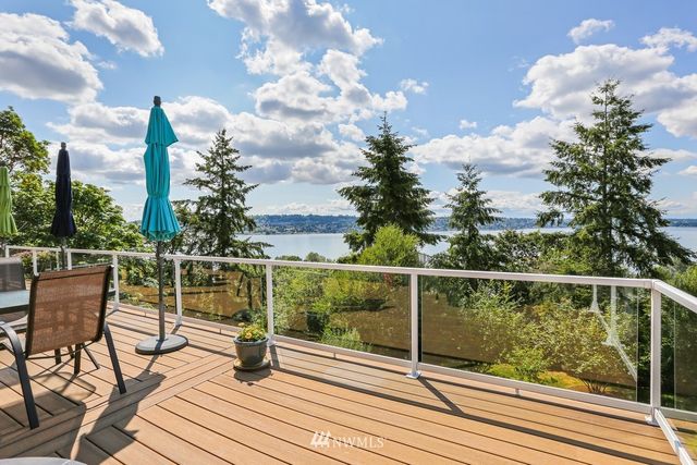 a front view of a house with a garden and outdoor seating