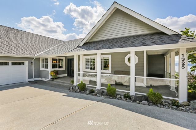 a front view of a house with outdoor seating
