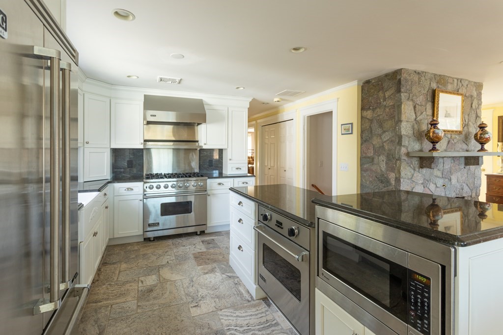 40 Bay Cotuit, MA 02635 - Photo 11 of 24 a kitchen with granite countertop a sink stove and refrigerator