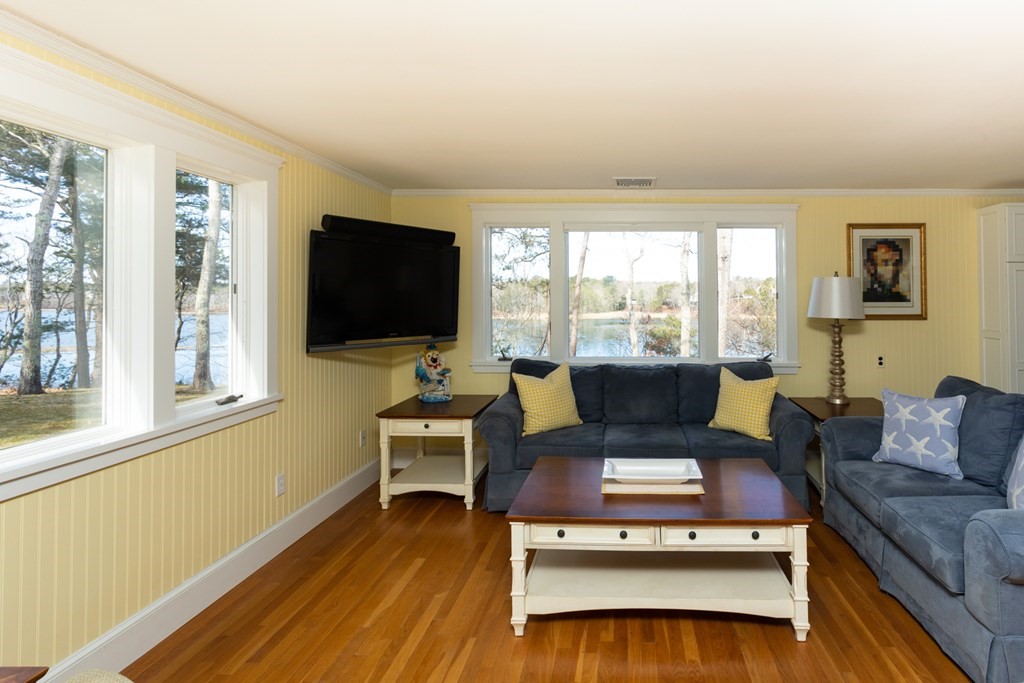 40 Bay Cotuit, MA 02635 - Photo 12 of 24 a living room with furniture a flat screen tv and a large window