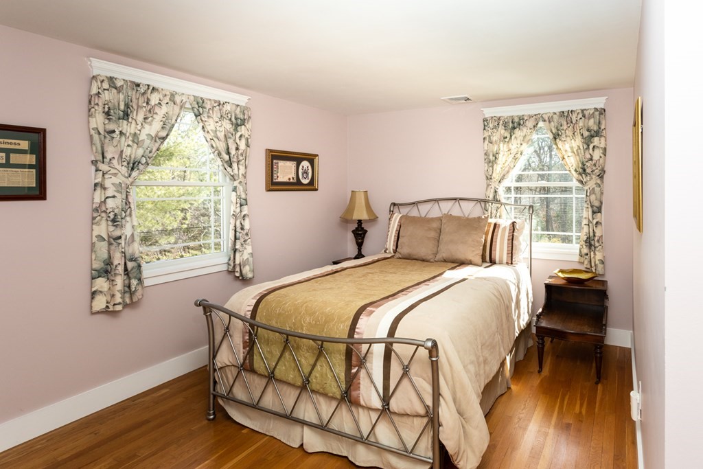 40 Bay Cotuit, MA 02635 - Photo 14 of 24 a bedroom with a bed and wooden floor