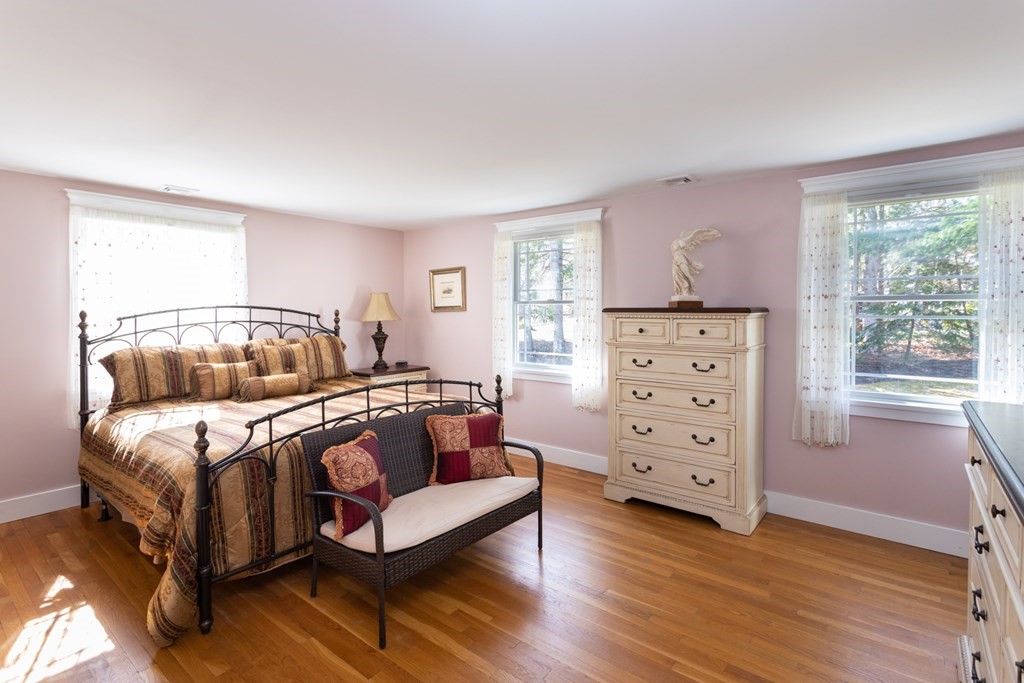 40 Bay Cotuit, MA 02635 - Photo 16 of 24 a bedroom with a bed and a dresser