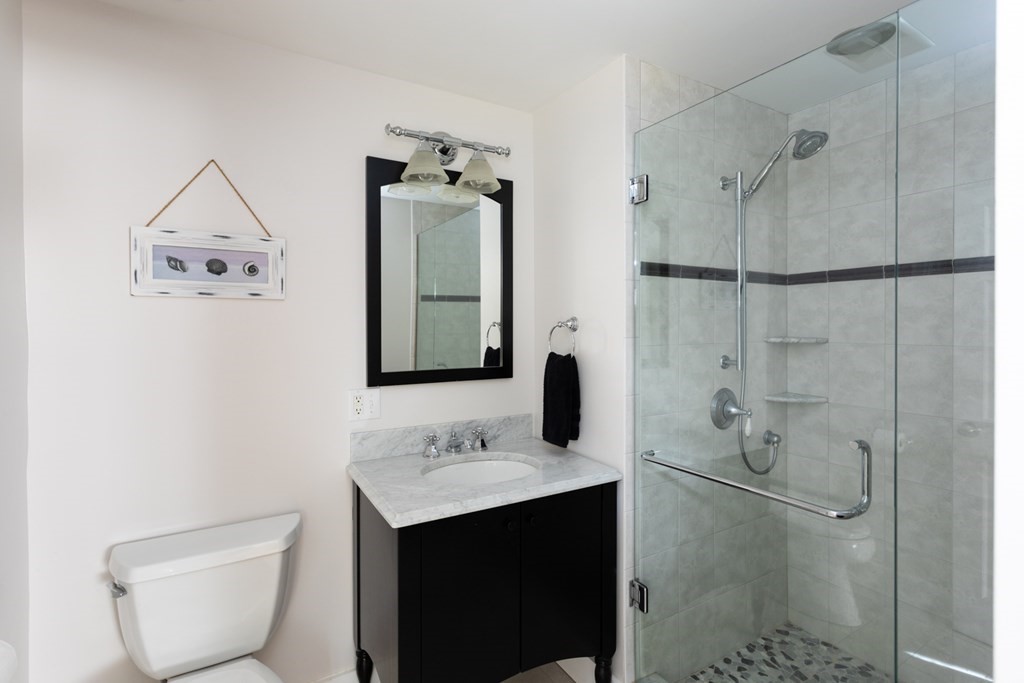 40 Bay Cotuit, MA 02635 - Photo 17 of 24 a bathroom with a sink toilet and shower