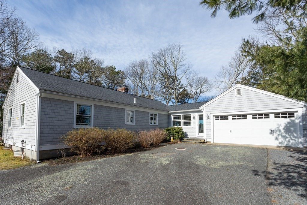 40 Bay Cotuit, MA 02635 - Photo 2 of 24 a view of a house with a yard and garage