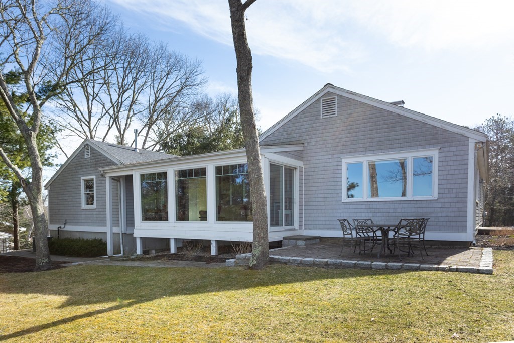 40 Bay Cotuit, MA 02635 - Photo 5 of 24 a view of a house with a yard patio and swimming pool