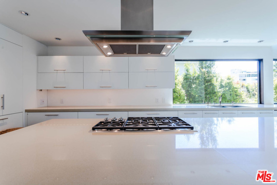 1440 North Kings Road Los Angeles, CA 90069 - Photo 11 of 37 a view of a stove top oven sitting inside of a kitchen