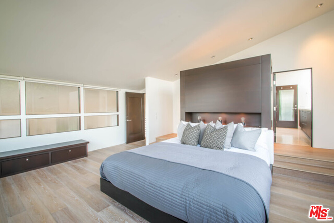 1440 North Kings Road Los Angeles, CA 90069 - Photo 14 of 37 a bedroom with a large bed and a flat screen tv