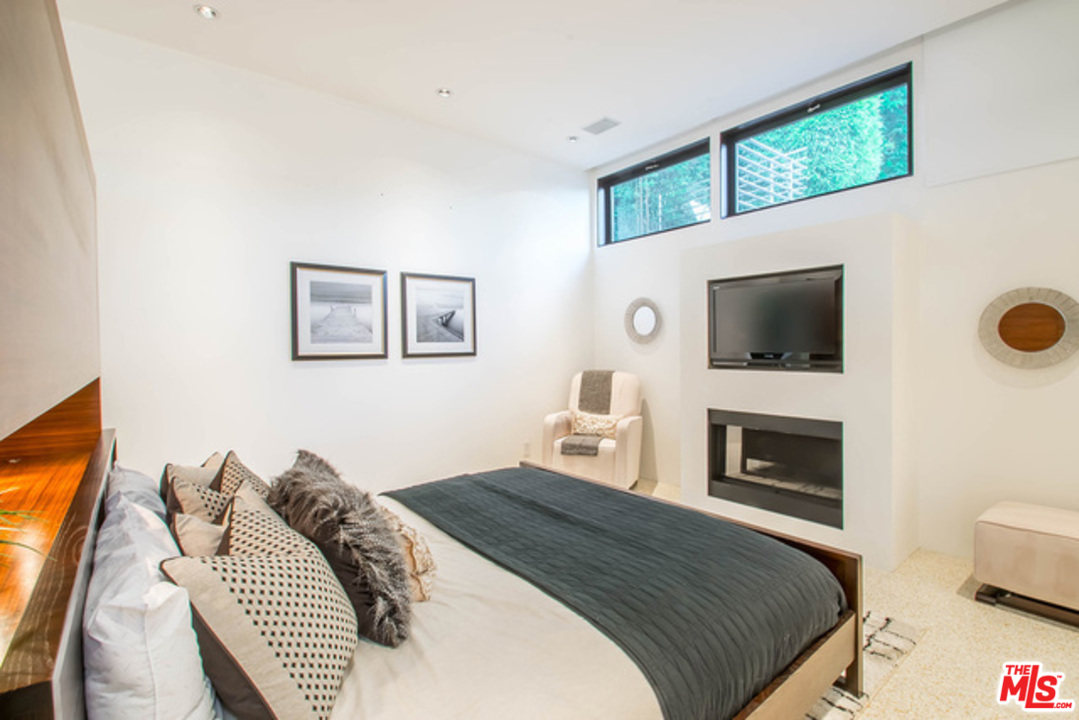 1440 North Kings Road Los Angeles, CA 90069 - Photo 22 of 37 a bedroom with a bed and a flat screen tv