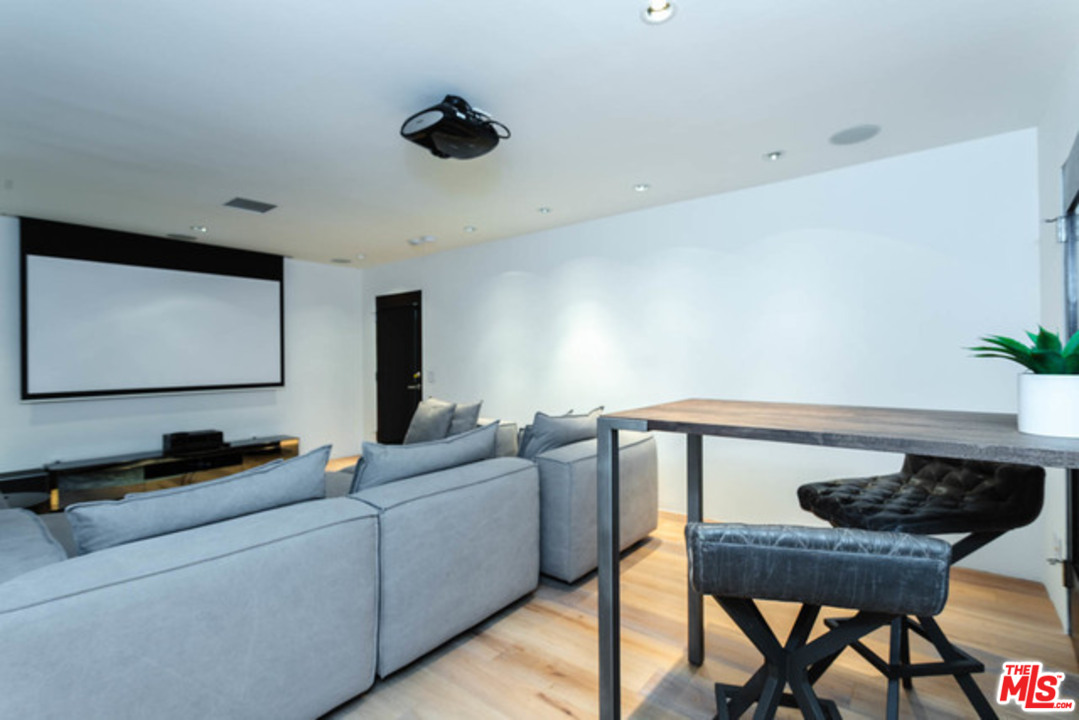 1440 North Kings Road Los Angeles, CA 90069 - Photo 25 of 37 a living room with furniture and a flat screen tv