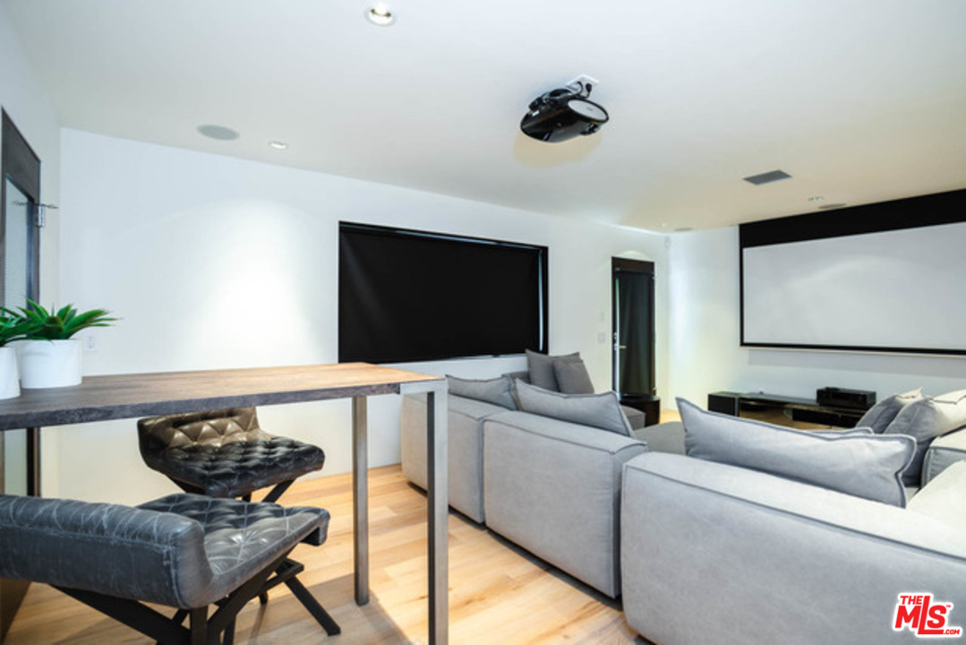 1440 North Kings Road Los Angeles, CA 90069 - Photo 26 of 37 a living room with furniture and a flat screen tv