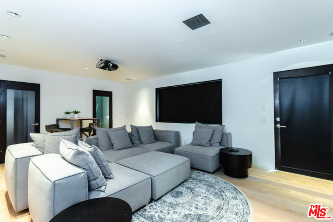 1440 North Kings Road Los Angeles, CA 90069 - Photo 28 of 37 a living room with furniture and a flat screen tv