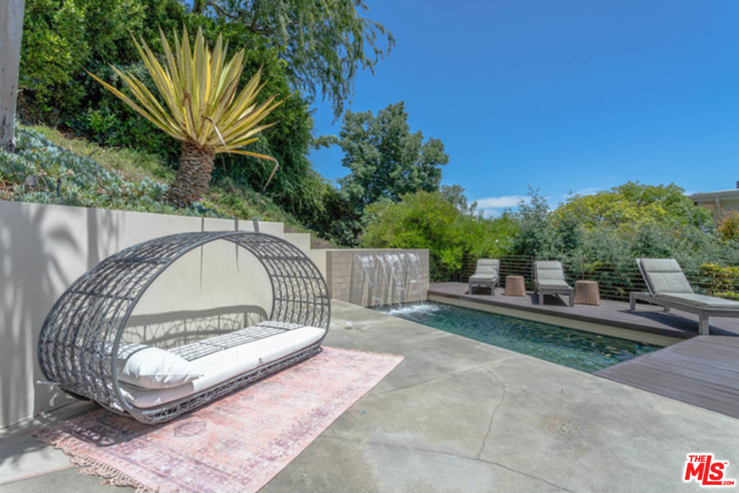 1440 North Kings Road Los Angeles, CA 90069 - Photo 30 of 37 a view of backyard with a garden and trees