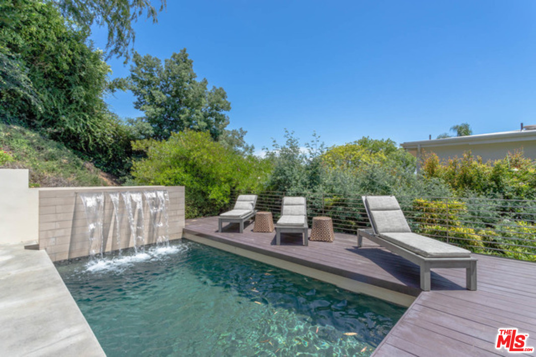 1440 North Kings Road Los Angeles, CA 90069 - Photo 31 of 37 a backyard of a house with table and chairs