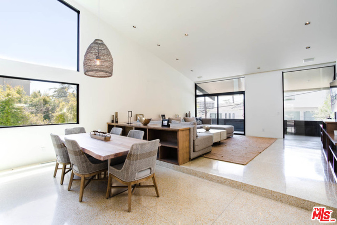 1440 North Kings Road Los Angeles, CA 90069 - Photo 5 of 37 a view of a dining room and livingroom with furniture wooden floor and a rug