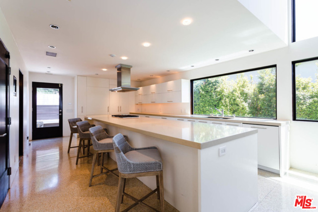 1440 North Kings Road Los Angeles, CA 90069 - Photo 6 of 37 a kitchen with a table and chairs in it