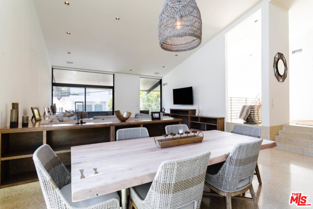 1440 North Kings Road Los Angeles, CA 90069 - Photo 8 of 37 a dining room with furniture a chandelier and window