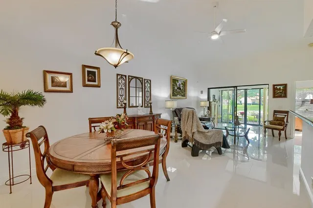 a dining room with furniture a chandelier and window
