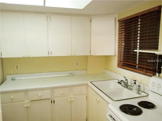 an aerial view of a house with a garden and lake view