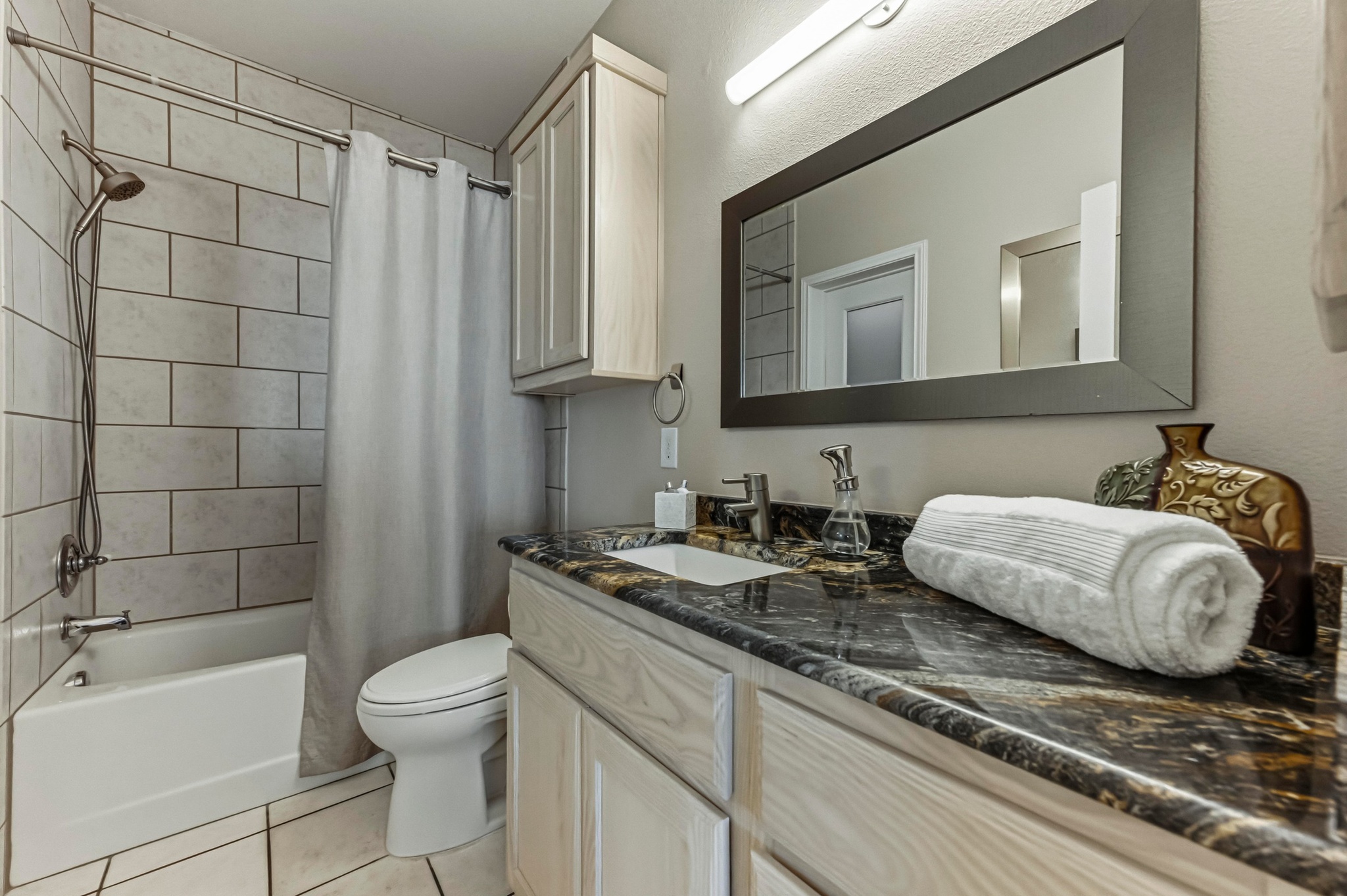 15943 Booth Circle Volente, TX 78641 - Photo 14 of 35 a bathroom with a granite countertop bathtub sink vanity mirror and toilet