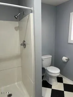 a white toilet sitting next to a bath tub
