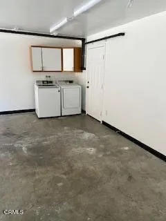 a view of kitchen with sink and refrigerator