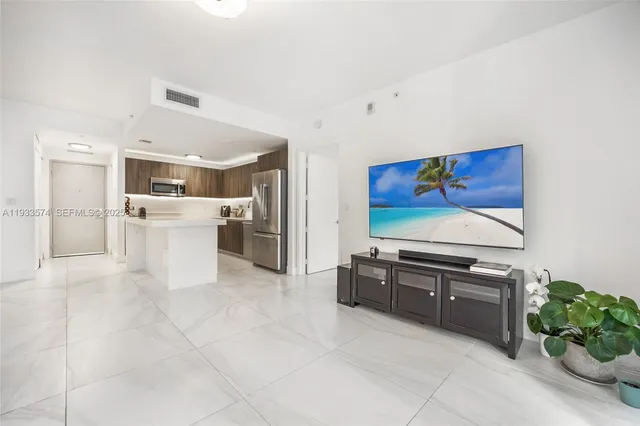 a kitchen with white cabinets and refrigerator