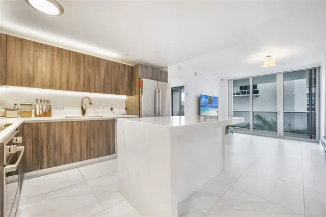 a living room with a bed furniture and a flat screen tv