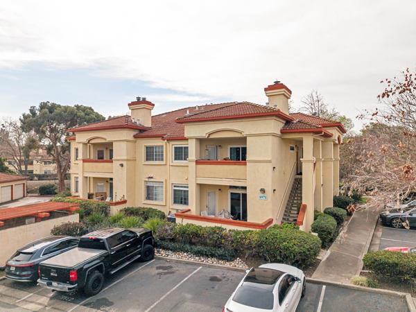 a car parked in front of a white house