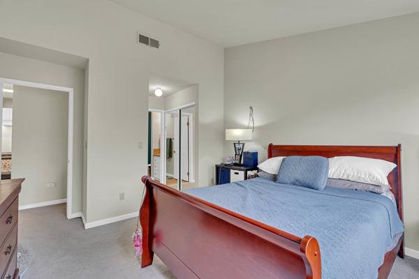 6971 Dublin Meadows Street, Unit F Dublin, CA 94568 - Photo 13 of 29 a bedroom with furniture and a lamp