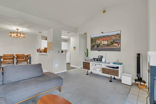 6971 Dublin Meadows Street, Unit F Dublin, CA 94568 - Photo 7 of 29 a living room with furniture and a flat screen tv