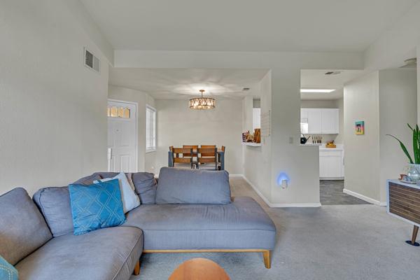 6971 Dublin Meadows Street, Unit F Dublin, CA 94568 - Photo 8 of 29 a living room with furniture and kitchen view
