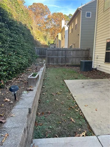 a view of a backyard with wooden fence