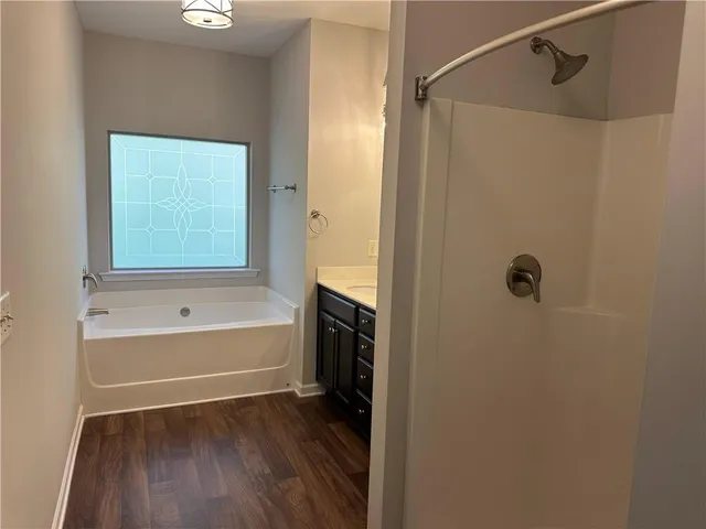 a bathroom with a bathtub and a shower