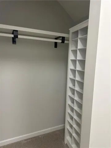 a view of walk in closet with empty racks