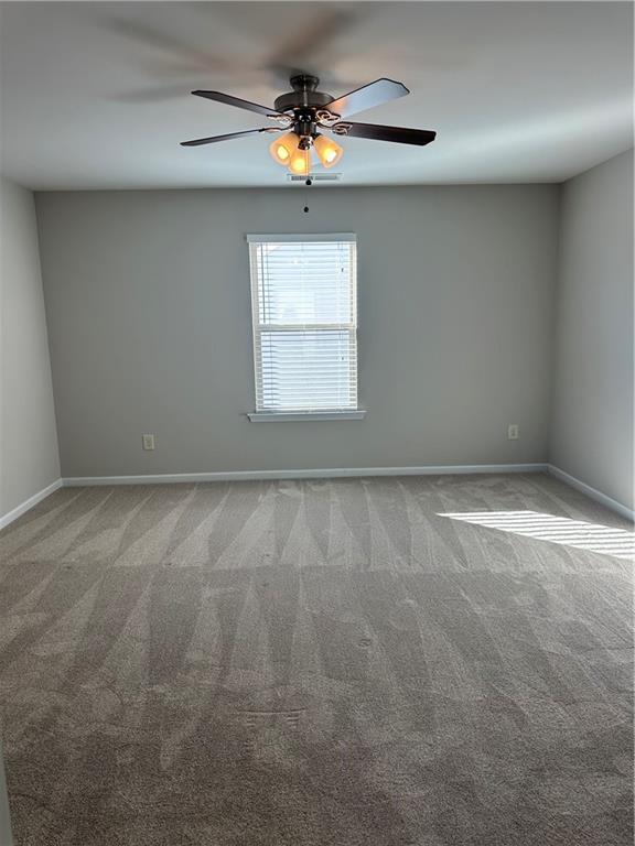 403 Village View Woodstock, GA 30188 - Photo 32 of 35 en empty room with windows and fan
