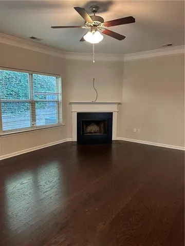 a living room with hard wood floors and a fireplace